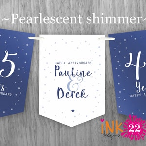 May include: Blue and white banner with the text "45 Years Happy Anniversary Pauline & Derek" and a white heart.