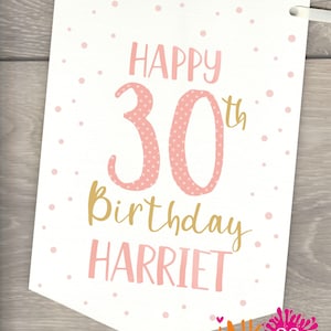 May include: A white banner with pink polka dots and gold lettering. The banner says "Happy 30th Birthday Harriet".