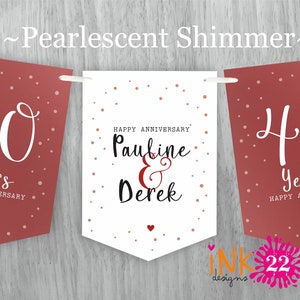 May include: A white banner with red polka dots and the text "Happy Anniversary Pauline & Derek" in black script. The banner is flanked by two red banners with white polka dots and the text "40 Years Happy Anniversary" in white script.