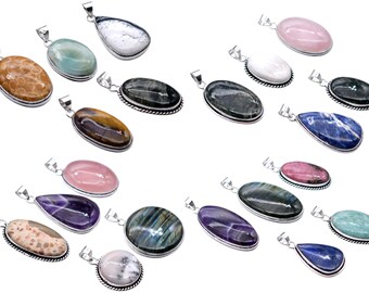 May include: Collection of gemstone pendants in various shapes and colors, including oval, teardrop, and irregular forms. Each pendant has a silver-colored metal setting and a loop for a chain. The gemstones display a range of colors, such as pink, blue, green, and brown.