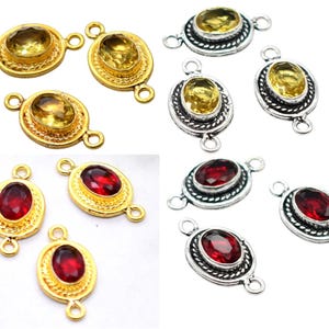 May include: Jewelry components featuring oval gemstones in gold and silver settings. The gemstones are yellow and red. Each component has two loops for attachment, ideal for jewelry making.