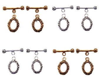 May include: An assortment of toggle clasps in gold and silver tones. Each clasp features a decorative oval pendant and a bar with decorative ends. Ideal for jewelry making and crafting.