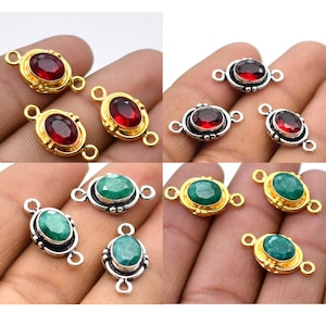 May include: An assortment of gemstone connector charms in gold and silver tones. The charms feature oval-shaped red and green gemstones. Each charm has two loops for attaching to jewelry designs.