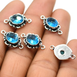May include: Five silver-tone connector charms with blue topaz gemstones. Each charm has two loops for attaching to jewelry.