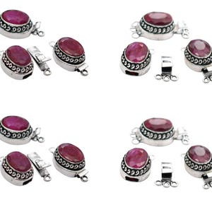 May include: Eight silver-tone jewelry clasps with red gemstone accents. Each clasp features a decorative border and three loops for attaching jewelry.