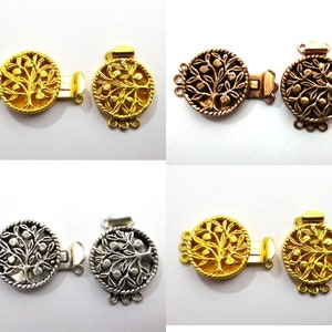 May include: Four pairs of gold, silver, and copper-toned metal clasps with a tree of life design. Each clasp has three loops for attaching to a necklace or bracelet.