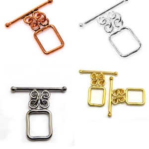 May include: Four toggle clasps in different finishes: silver, gold, rose gold, and gunmetal. Each clasp features a square loop and a sliding bar.