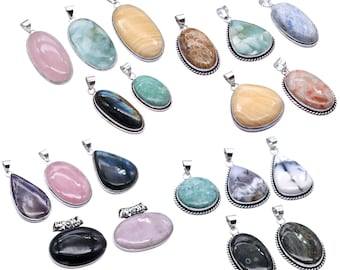 May include: Collection of gemstone pendants in various shapes and colors, including pink, blue, yellow, and green. Each pendant has a silver-colored metal setting. The gemstones are oval, teardrop, and irregular shapes.