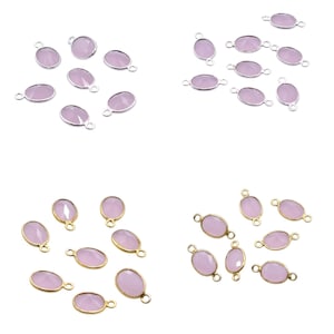May include: Four sets of oval-shaped, light purple gemstone connectors. Two sets have silver-colored metal settings, and two sets have gold-colored metal settings. Each connector has a small loop on each end for attaching to other jewelry components.
