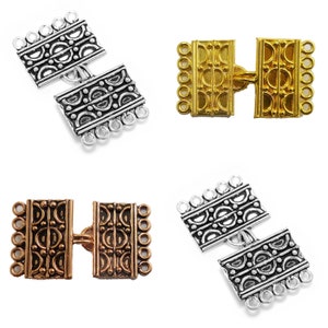 May include: Four silver, gold, and bronze toggle clasps with ornate designs. Each clasp has two rectangular pieces with a decorative pattern and multiple loops on each side.