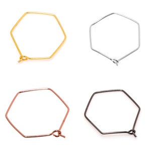 May include: Four hexagonal hoop earrings in different finishes: gold, silver, rose gold, and black.
