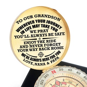 May include: A gold compass in a black box with a wooden lid. The lid has a message for a grandson: "Wherever your journey in life may take you, you'll always be safe. Enjoy the ride and never forget your way back home. We're always here for you. Love, Nana & Papa."