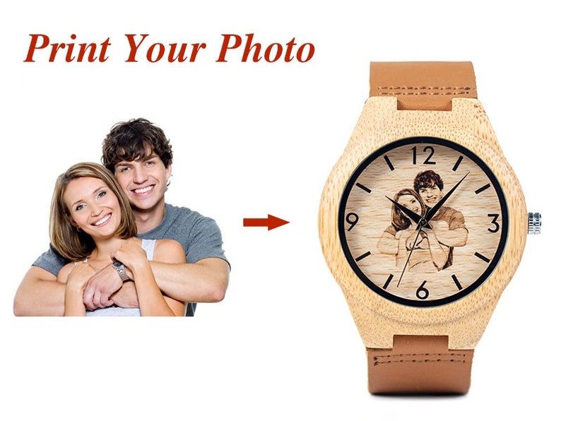 May include: A wooden wristwatch with a brown leather band. The watch face has a black background with white numbers and hands. A photo of a couple is engraved on the watch face. The text "Print Your Photo" is displayed above the watch.