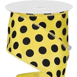 May include: Yellow ribbon with black polka dots.
