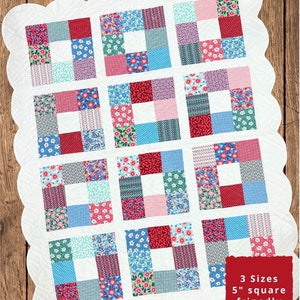 Puede incluir: Un patrón de colcha para una "Grace Quilt" en tres tamaños: bebé (41" x 41"), regazo (55" x 70") y grande (72" x 87"). La colcha está hecha con un patchwork de telas coloridas en tonos de rosa, azul, rojo y verde. El patrón está diseñado para cuadrados de 5".