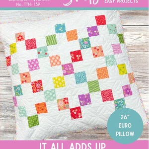 May include: White quilted pillow with a patchwork design. The pillow features squares in various colours and patterns. Text on the pillow reads "IT ALL ADDS UP" and "26" EURO PILLOW". The pillow measures 66 cm by 66 cm.