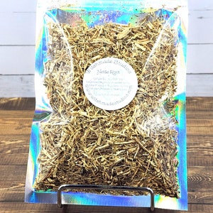 May include: A clear plastic bag filled with dried nettle root. The bag has a label that says "Wishmade Studios" and "Nettle Root".