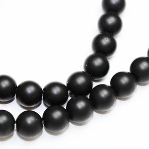 May include: A strand of black matte round beads. The beads are strung together on a clear thread.