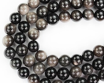 May include: A strand of black and gray gemstone beads. The beads are round and have a smooth, polished finish.