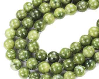 May include: A strand of green jade beads, each bead is round and smooth. The beads are strung together on a clear thread.