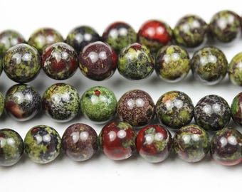 Könnte beinhalten: Eine Strähne runder, grün, rot und braun gesprenkelter Perlen. Die Perlen haben einen Durchmesser von etwa 8 mm.