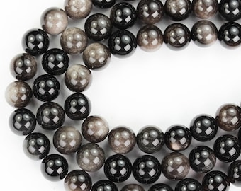 May include: A strand of black and gray gemstone beads. The beads are round and have a smooth, polished finish.