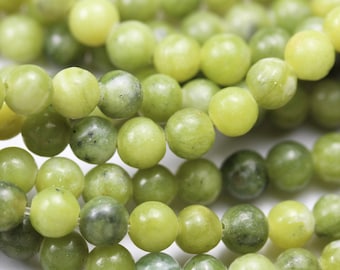 May include: A strand of round, light green jade beads. The beads are smooth and polished, with a slight variation in colour.