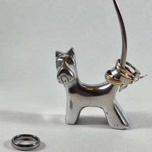 Schnauzer ring holder crafted from silver-finished metal, designed to accommodate a wide range of ring types.