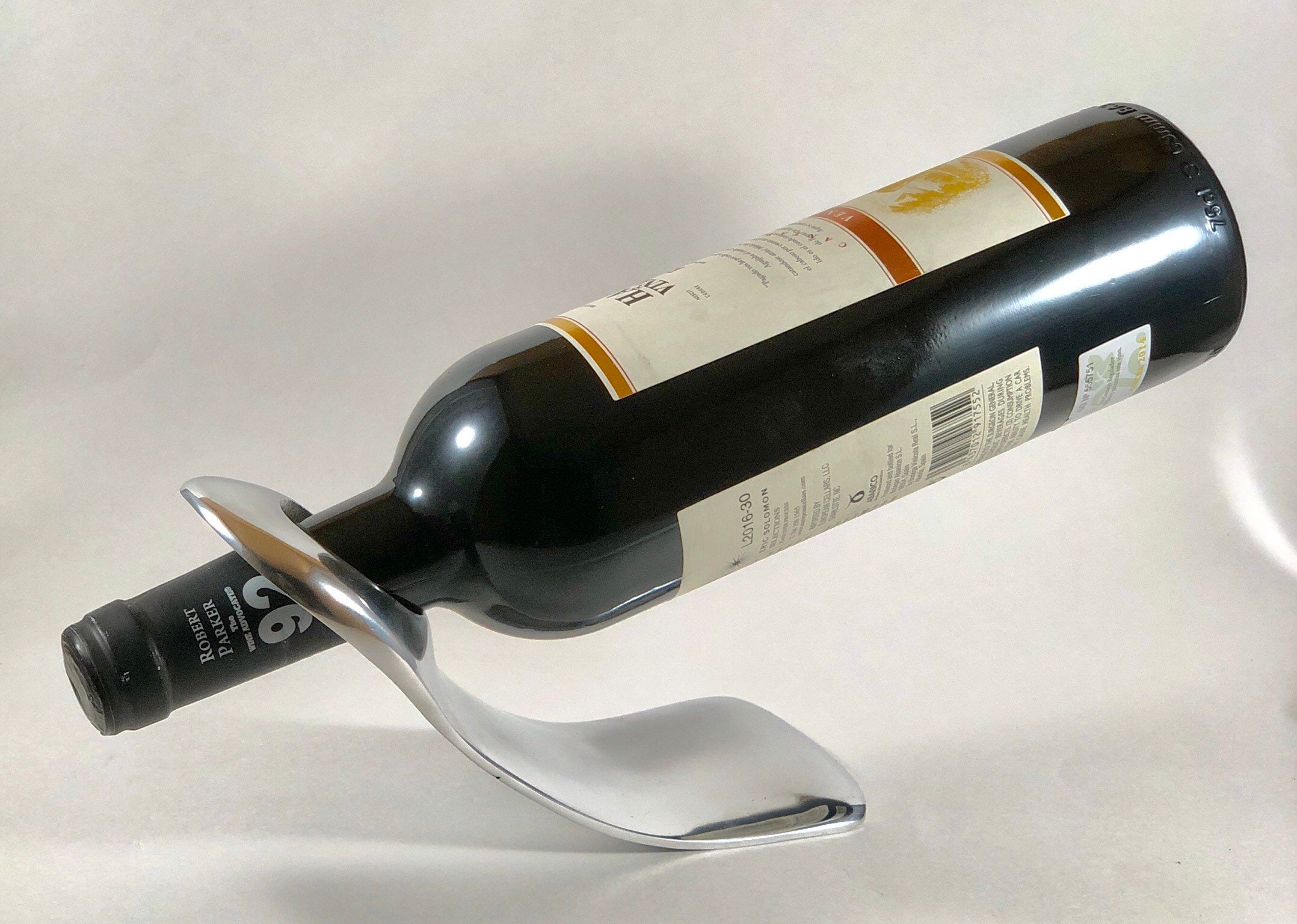 Sleek chrome-finished single wine bottle holder.