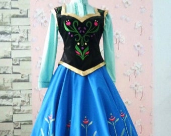 May include: A blue and purple princess dress with a black bodice featuring a floral design. The dress has a long skirt with a scalloped hem and floral embroidery.