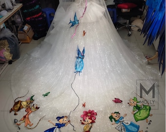 May include: A white tulle wedding veil with a sparkly finish and embroidered cartoon characters. The characters include a mouse holding a balloon, a mouse with a flower, and a mouse with a basket. The veil is decorated with blue birds and pink ribbons.