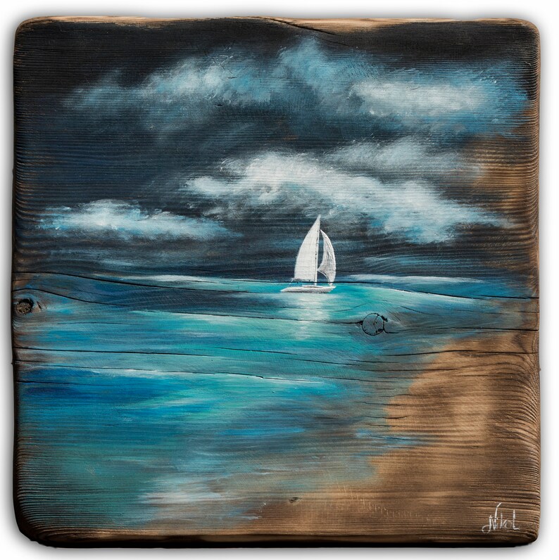 May include: A painting on a piece of wood depicting a sailboat on a blue ocean with white clouds in a dark blue sky.