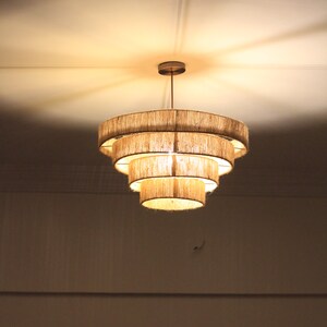 Rustic macrame chandelier hanging in a cozy farmhouse living room.