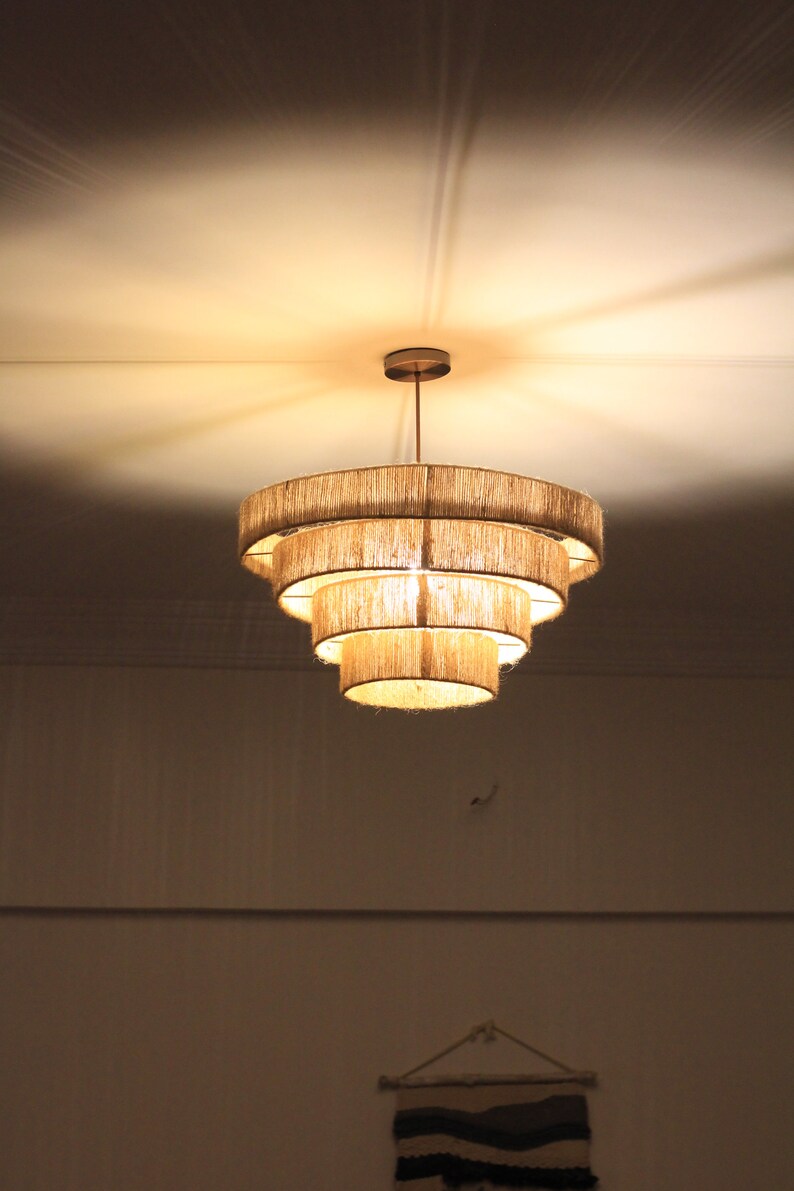 Rustic macrame chandelier hanging in a cozy farmhouse living room.