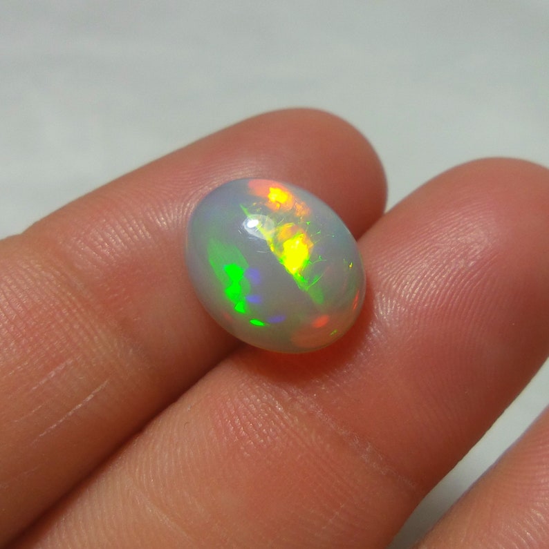 3.24 Carat 12.5x10.2x5.7 MM Natural Top Grade Green Red Yellow Rainbow Fire Ethiopian Opal Oval Shape Cabochon,Multi Fire Welo Opal Stone 3.24 Carat 12.5x10.2x5.7 MM Natural Top Grade Green Red Yellow Rainbow Fire Ethiopian Opal Oval Shape Cabochon,Multi Fire Welo Opal Stone