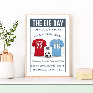 May include: A framed print with a football theme. The text reads "THE BIG DAY" and "OFFICIAL FIXTURE". It features red and blue jerseys with numbers, a football, and the text "They came. They saw. They said 'I do'".