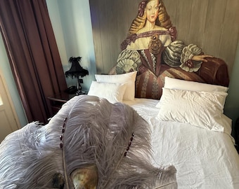 A purple hand-held feather fan