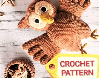 May include: Crochet pattern for a brown owl amigurumi toy. The owl is lying on a white wooden surface with a yellow tag that says "CROCHET PATTERN".