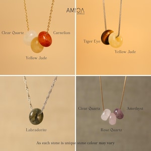 May include: Four necklaces with different gemstone pendants: clear quartz, carnelian, yellow jade, tiger eye, yellow jade, labradorite, clear quartz, rose quartz, and amethyst. Each necklace has a delicate chain. The text "AMIOA JEWELS" is in the top right corner.
