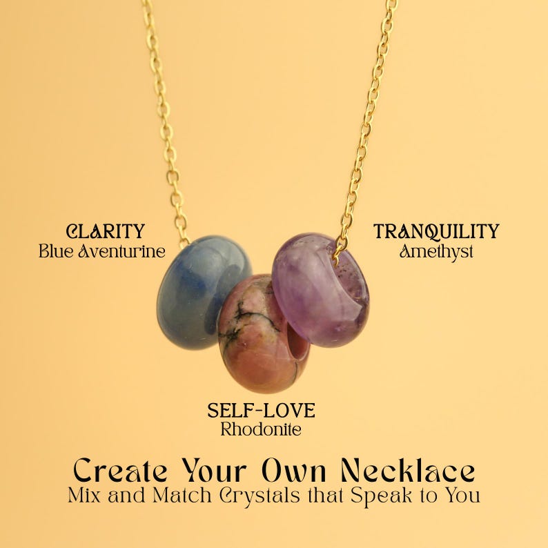 May include: A gold chain necklace featuring three gemstone pendants: blue aventurine, rhodonite, and amethyst. The text on the image reads "CLARITY", "SELF-LOVE", and "TRANQUILITY". The necklace is displayed against a yellow background.