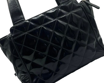 CHANEL. Black patent leather baguette with checkerboard …