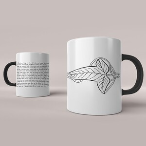May include: White ceramic mug with a black handle. The mug features a black and white illustration of a leaf with a vine wrapping around it. The text on the mug reads: "The trees throng to the old tales and songs. Mr. Frodo..."