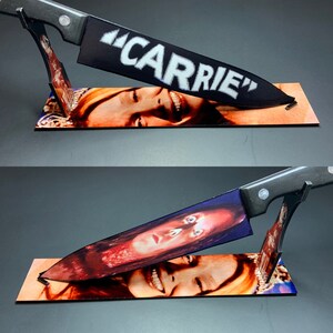 May include: A black kitchen knife with the word "CARRIE" written on the blade is partially inserted into a photo of a woman's face. The woman's face is contorted in a look of fear and surprise.