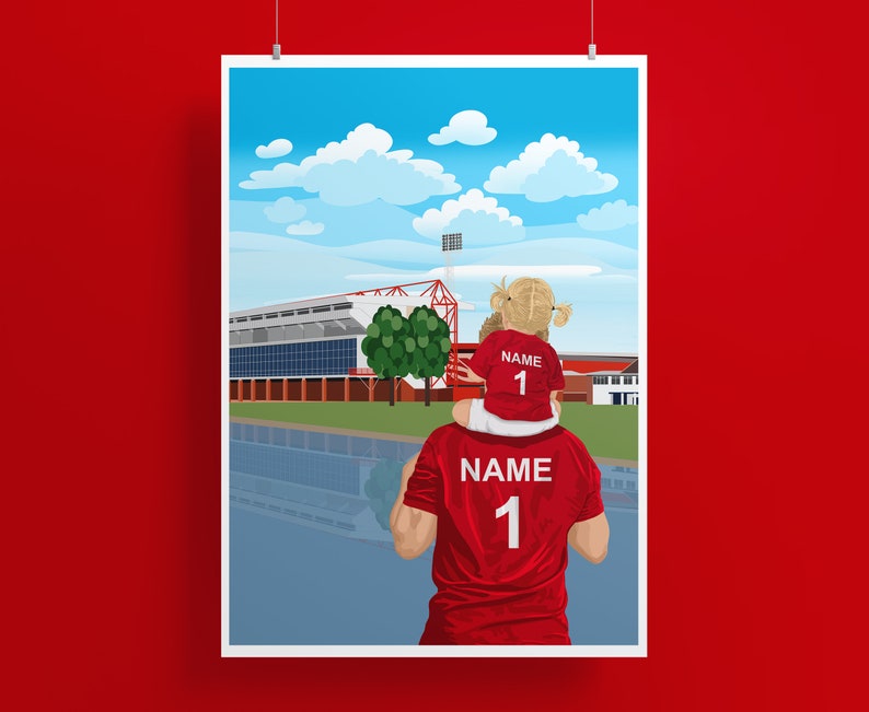 May include: A father and daughter wearing red soccer jerseys with the number "1" on the back, standing in front of a soccer stadium. The daughter is sitting on the father's shoulders. The sky is blue with white clouds.