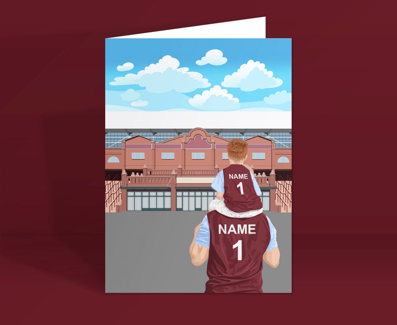 May include: A father and son wearing matching maroon and blue jerseys with the number "1" and the word "NAME" on the back. They are standing in front of a brick building with a blue sky and white clouds in the background.