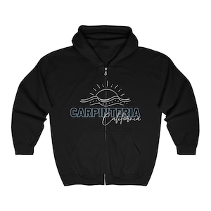 May include: Black zip-up hoodie with a white graphic of a sun setting over waves and the text "Carpinteria California" in blue and white.