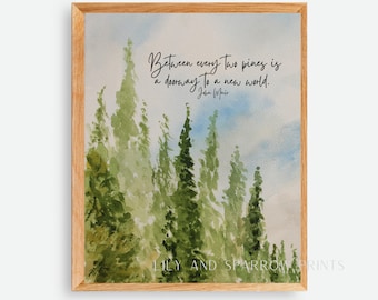 May include: A watercolor painting of a forest with a quote by John Muir: "Between every two pines is a doorway to a new world." The painting is framed in a light brown wood frame.