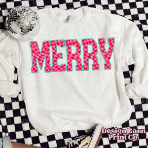 May include: White sweatshirt with a pink and red checkered "Merry" graphic.