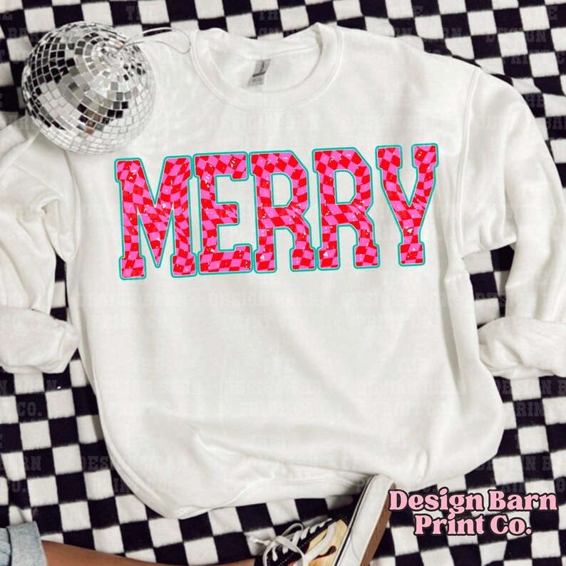 May include: White sweatshirt with a pink and red checkered "Merry" graphic.