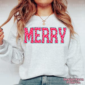 May include: A gray sweatshirt with the word "MERRY" printed in large, bold letters. The letters are pink and white checkered with a blue outline.